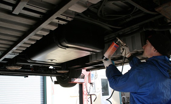 This photograph shows the underseal being applied.